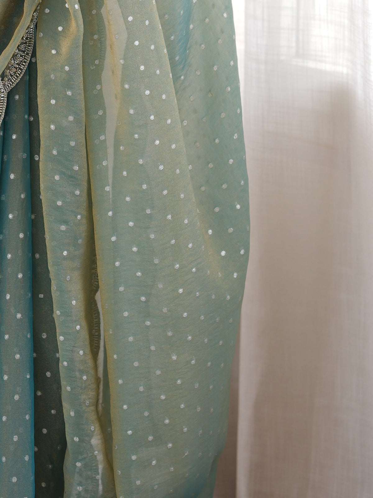 Pallu detail of light blue silk blend saree showing ornamented surface design and scallop border