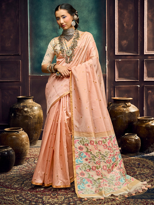 Woman wearing peach cotton silk saree with zari butta (metallic motif) work and peach blouse