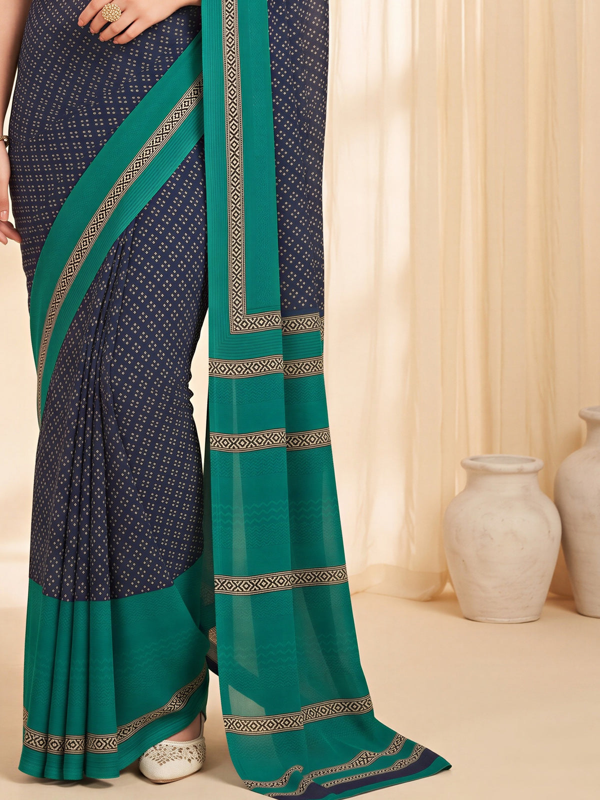 Pallu detail of navy blue crepe saree showing paisley (kairi) motif work and printed border