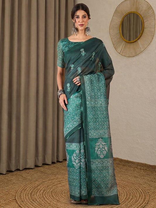 Woman wearing teal green silk blend saree with all-over floral design and teal green blouse