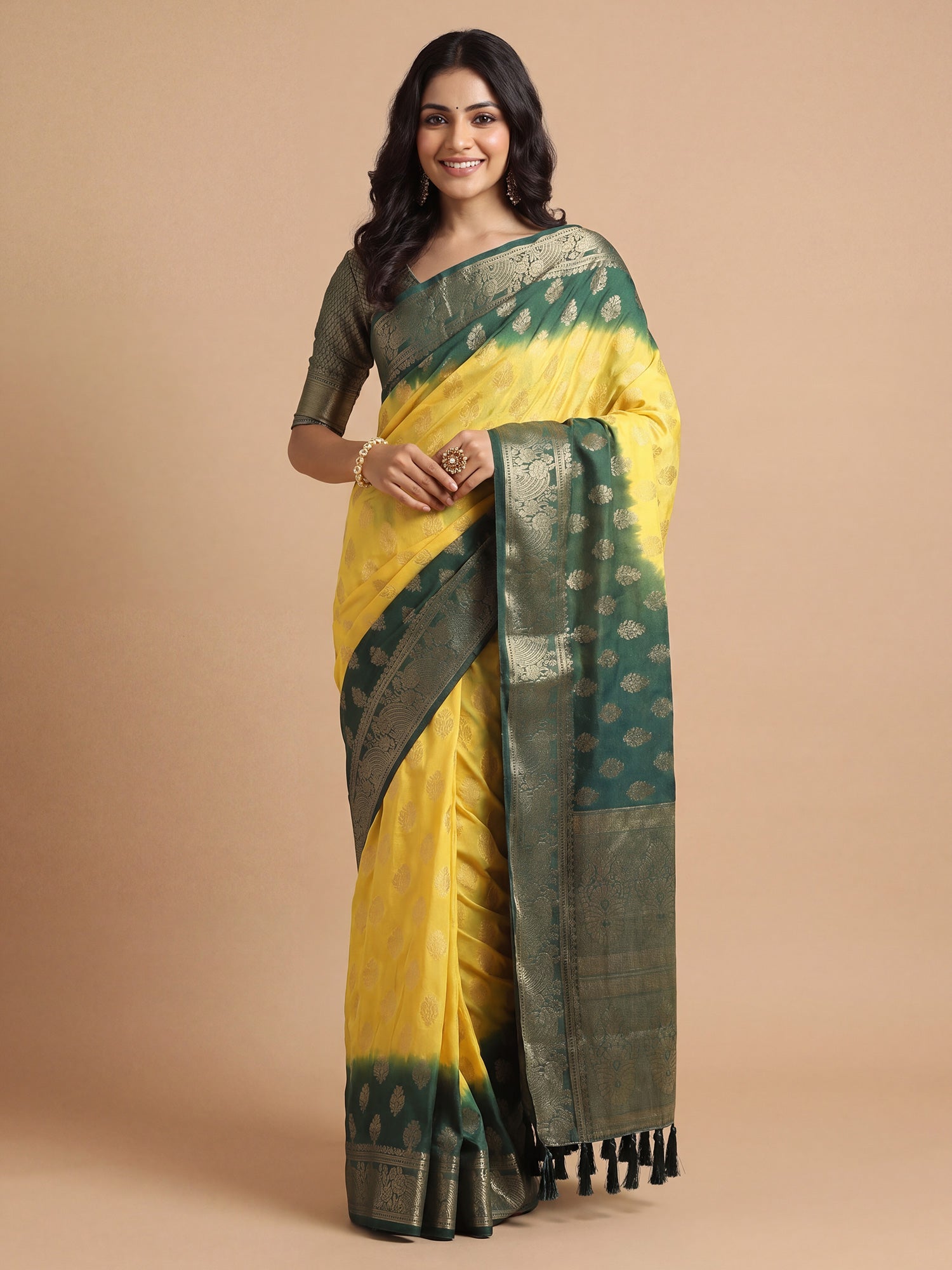 Woman wearing yellow georgette saree with zari butta (metallic motif) work and green blouse
