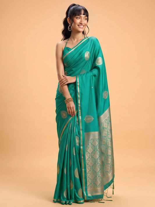 Woman wearing teal green satin silk saree with zari butta (metallic motif) work and teal green blouse