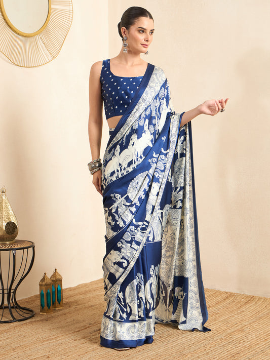 Woman wearing blue crepe saree with kalamkari narrative motif work and blue blouse