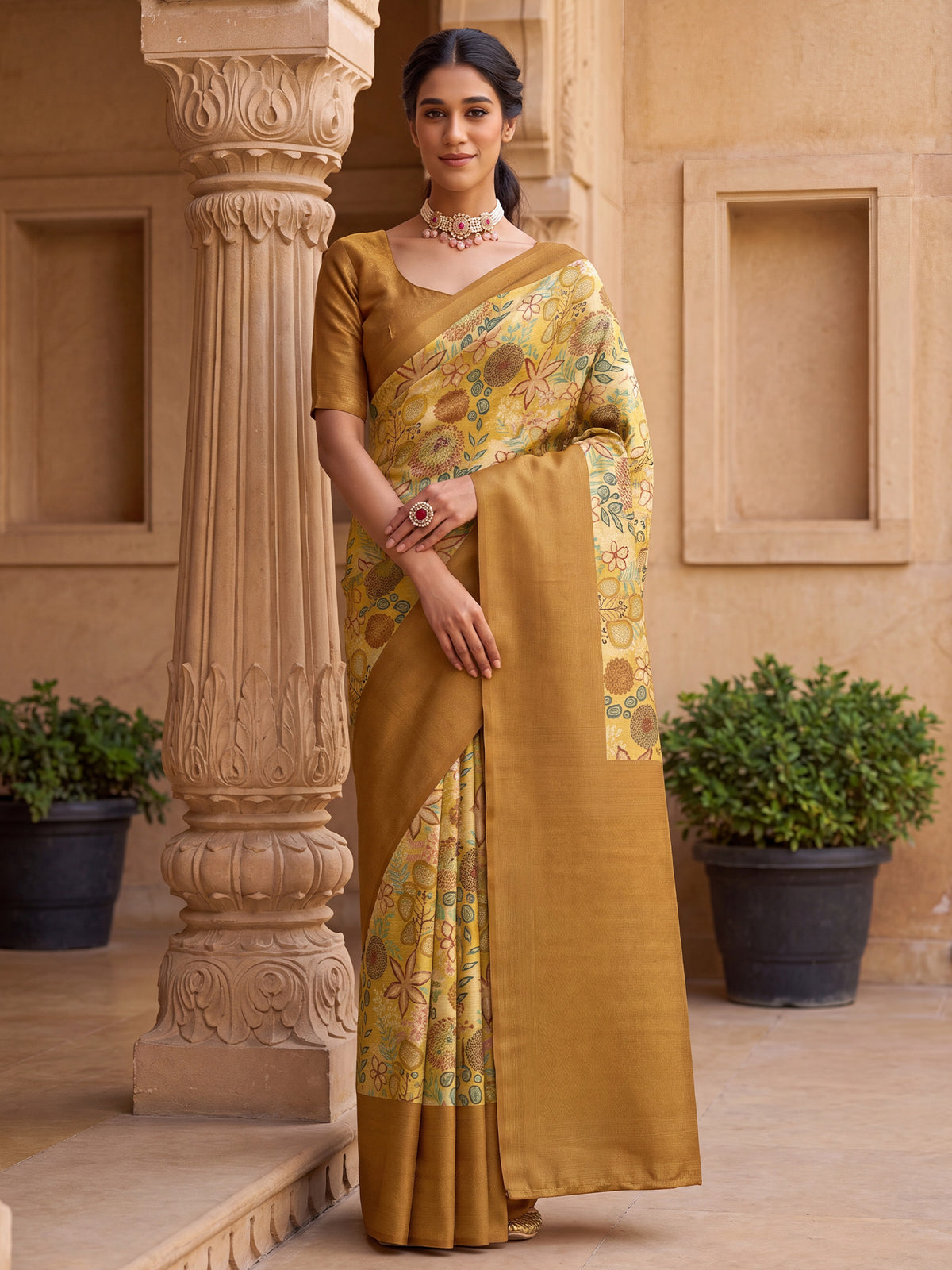 Woman wearing mustard silk blend saree with all-over floral design and mustard blouse