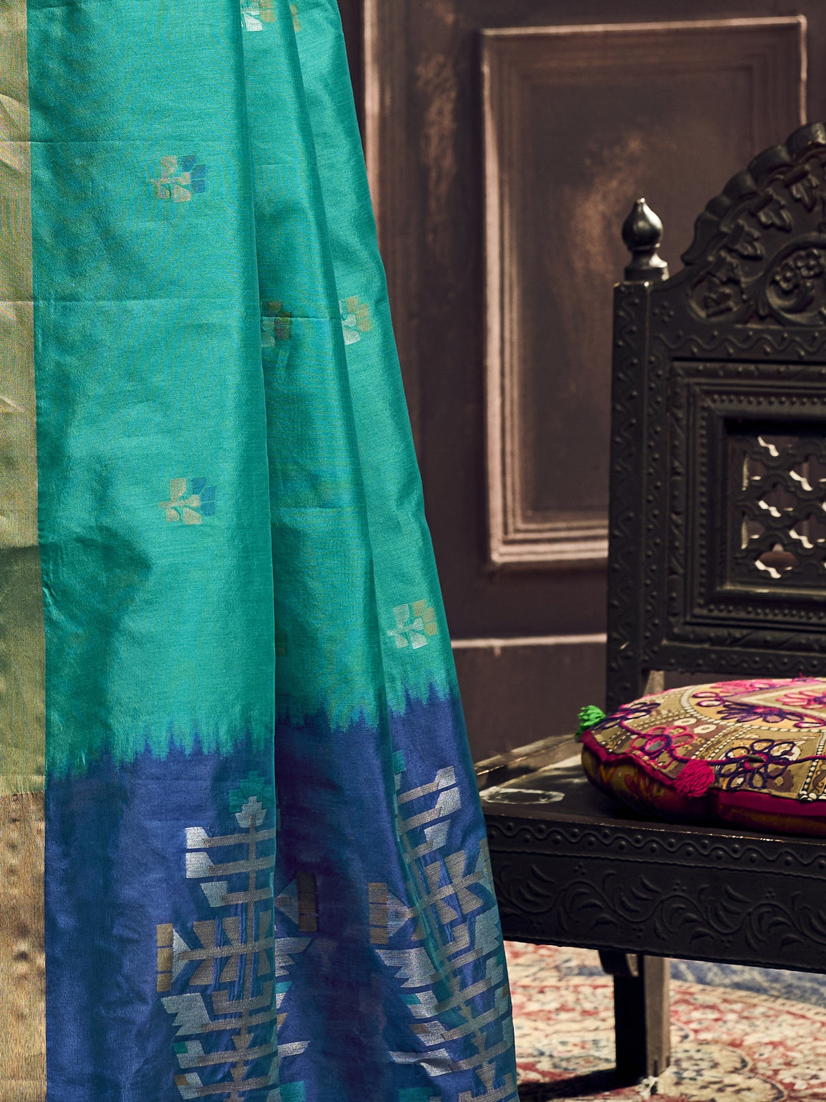 Pallu detail of teal blue silk blend saree showing zari butta (metallic motif) work and zari border