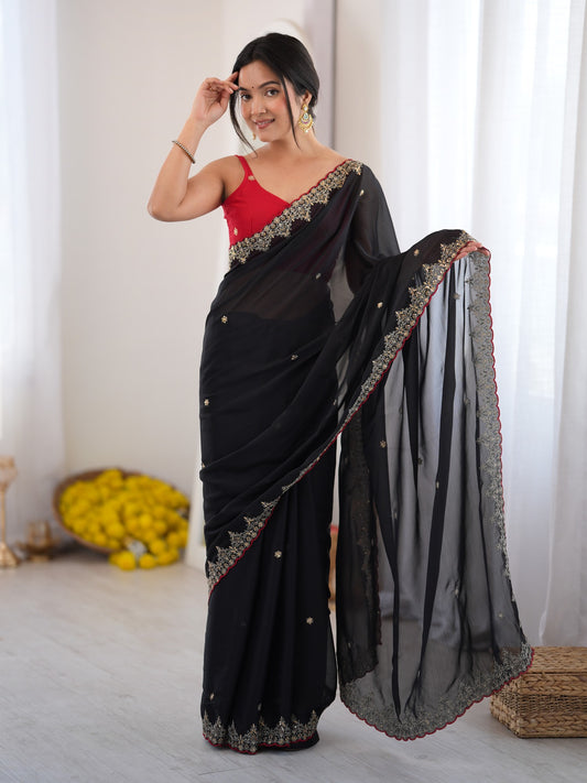 Woman wearing black georgette saree with ornamented surface design and red blouse