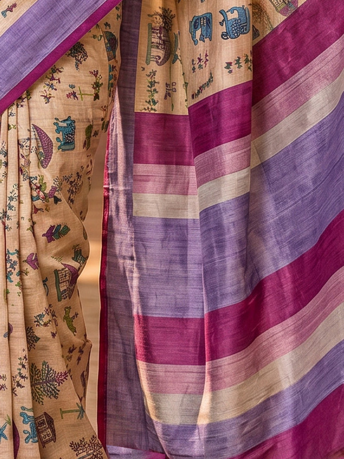 Pallu detail of peach soft silk saree showing tribal folk-art motifs and printed border