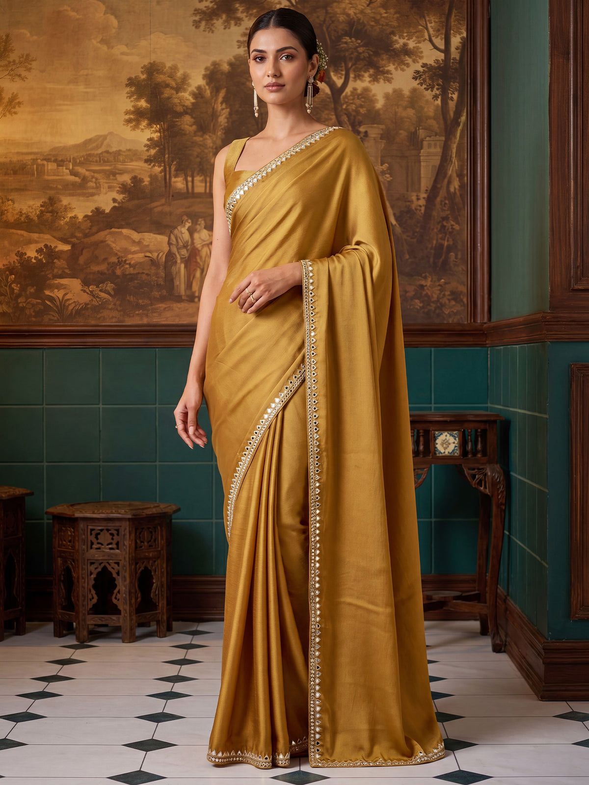 Woman wearing mustard satin saree with clean solid-tone finish and mustard blouse