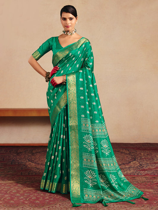 Woman wearing teal green tussar silk saree with traditional indian motif work and teal green blouse