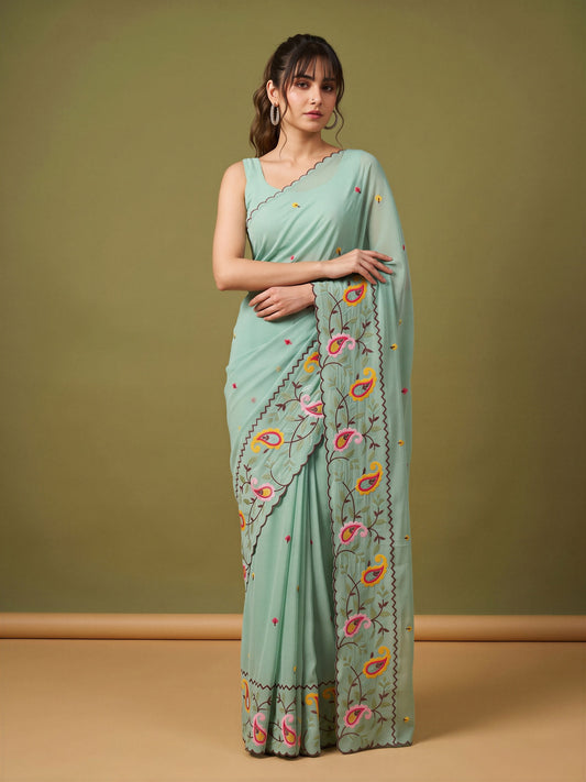Woman wearing light blue georgette saree with embroidered motif work and light blue blouse