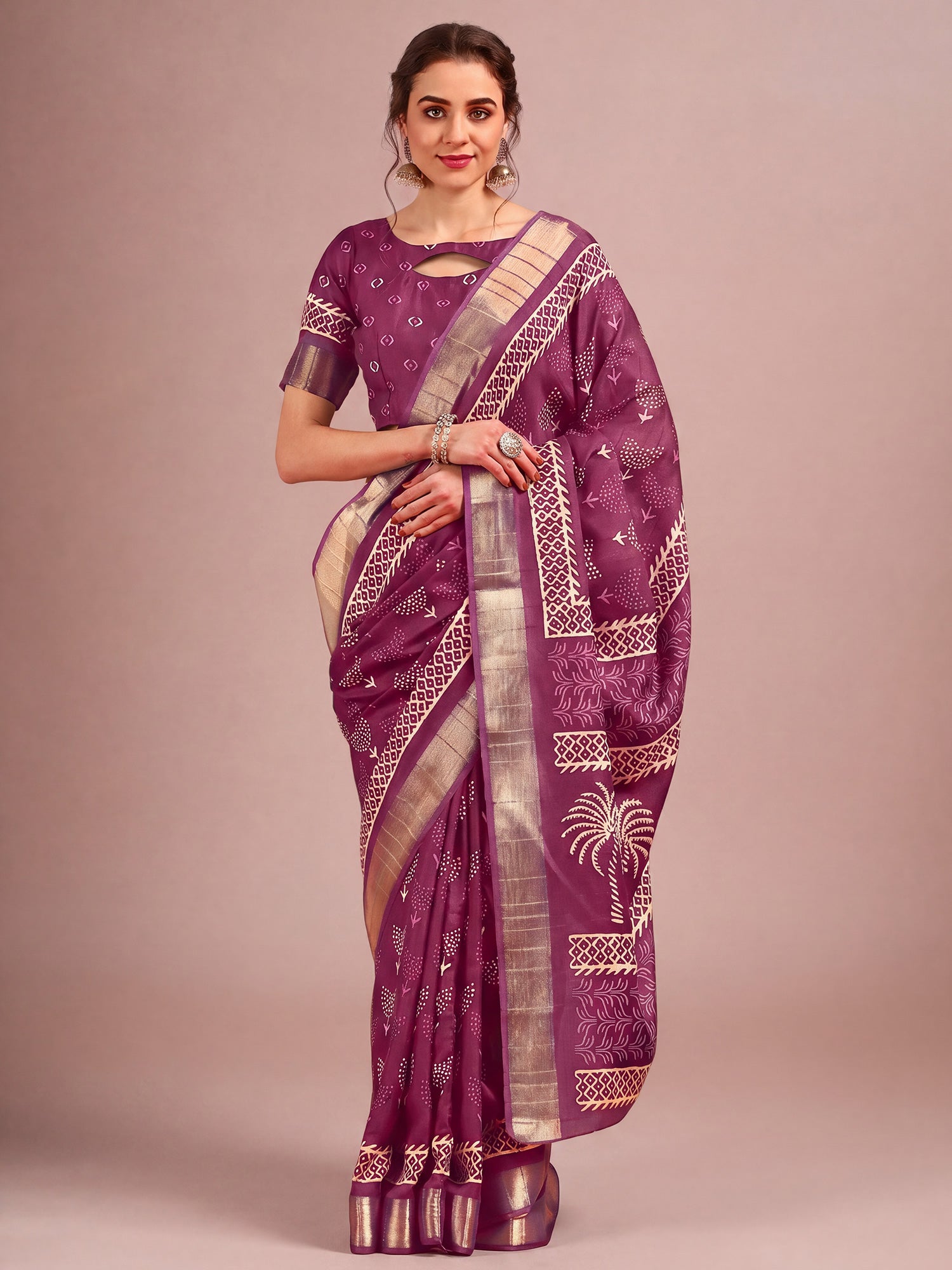 Woman wearing purple cotton silk saree with traditional indian motif work and purple blouse
