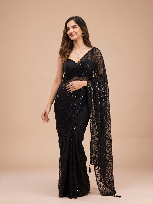 Woman wearing purple net saree with embroidered motif work and purple blouse