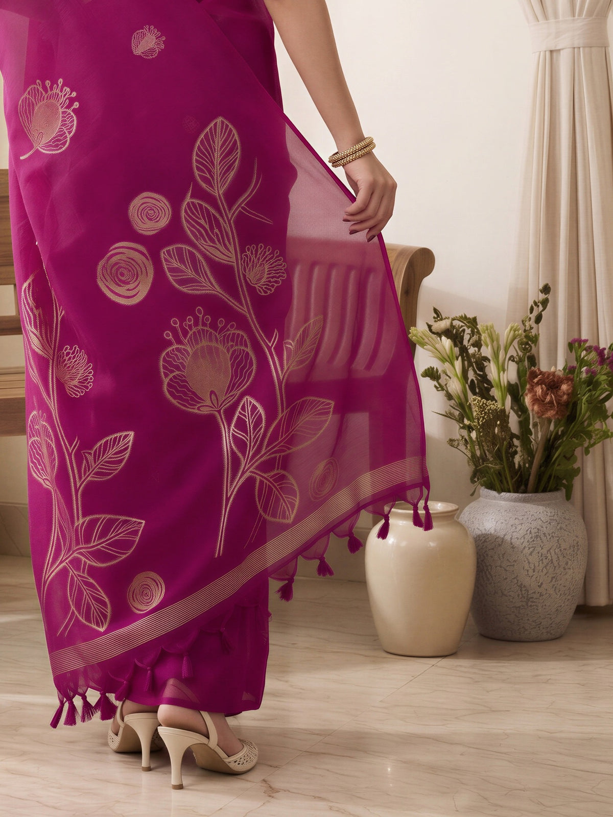 Pallu detail of pink pure silk saree showing all-over floral design and solid border