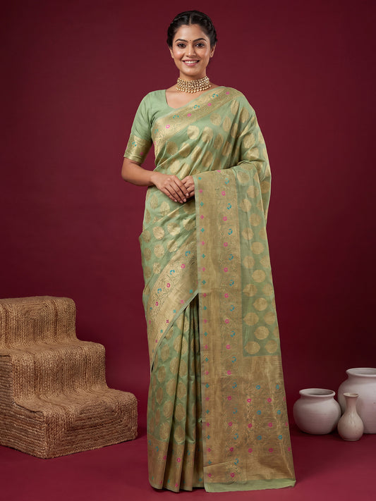 Woman wearing mint green silk blend saree with zari butta (metallic motif) work and mint green blouse