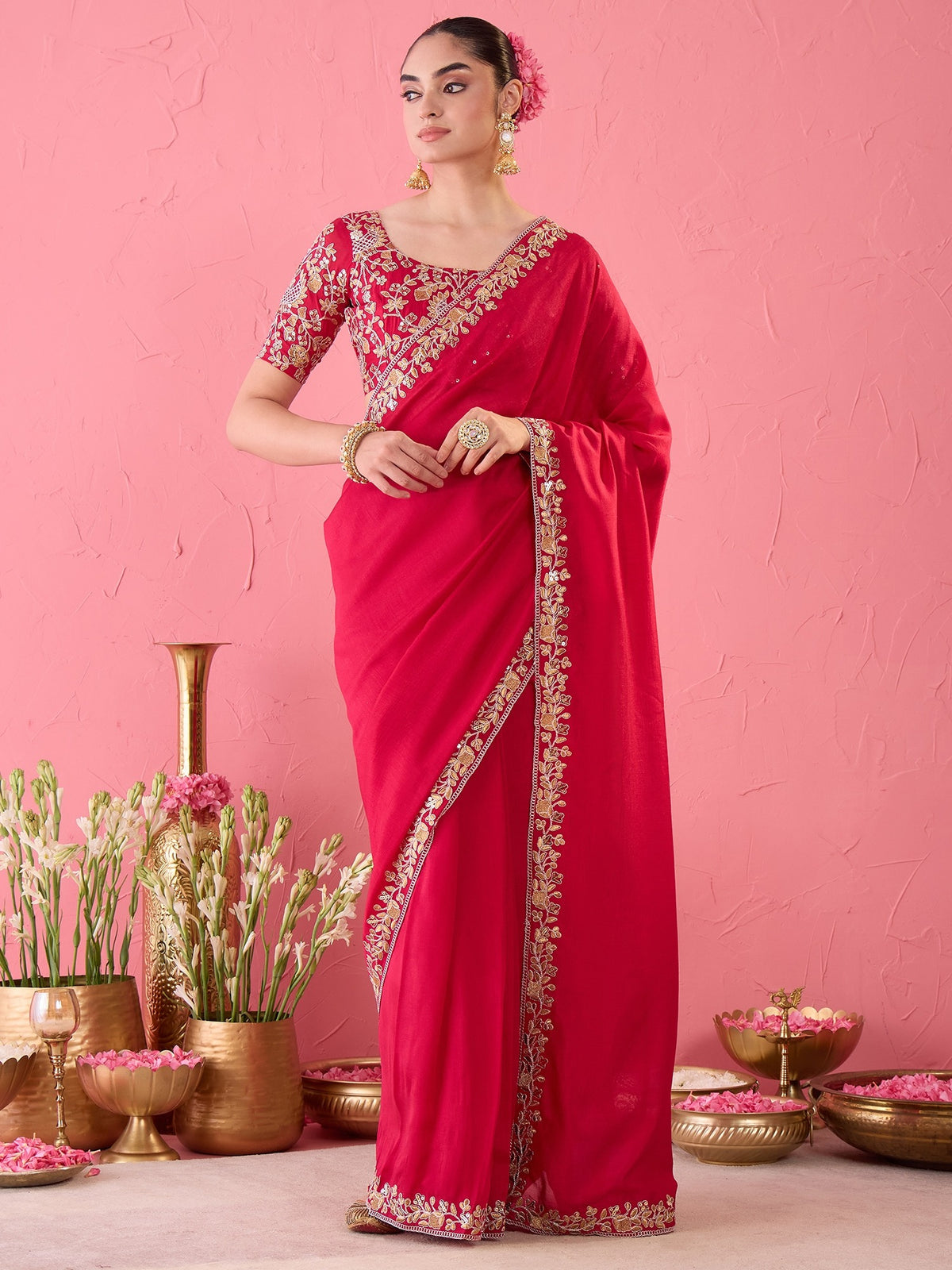 Woman wearing pink vichitra silk ready to wear saree with ornamented surface design and pink blouse