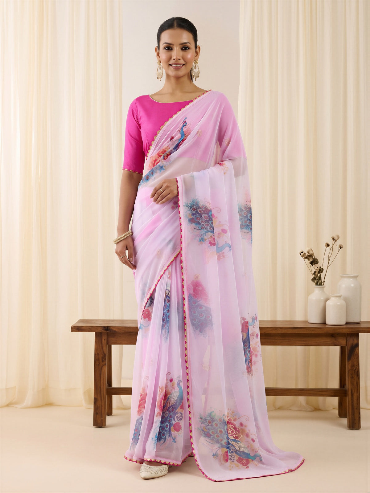 Woman wearing lavender georgette saree with metallic foil print work and pink blouse