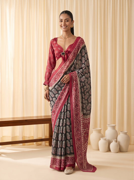 Woman wearing black satin saree with ajrak block-print motif work and maroon blouse