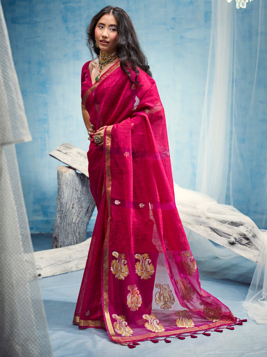 Woman wearing pink muga silk saree with zari butta (metallic motif) work and pink blouse