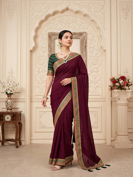 Woman wearing wine vichitra silk saree with clean solid-tone finish and green blouse