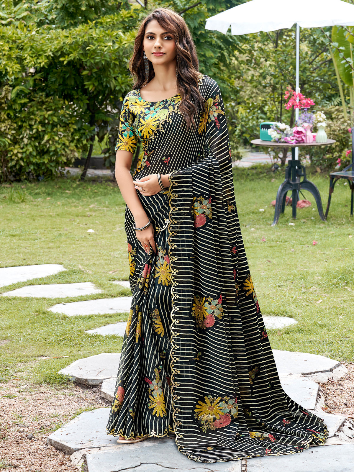 Woman wearing black chiffon saree with metallic foil print work and multicolored blouse