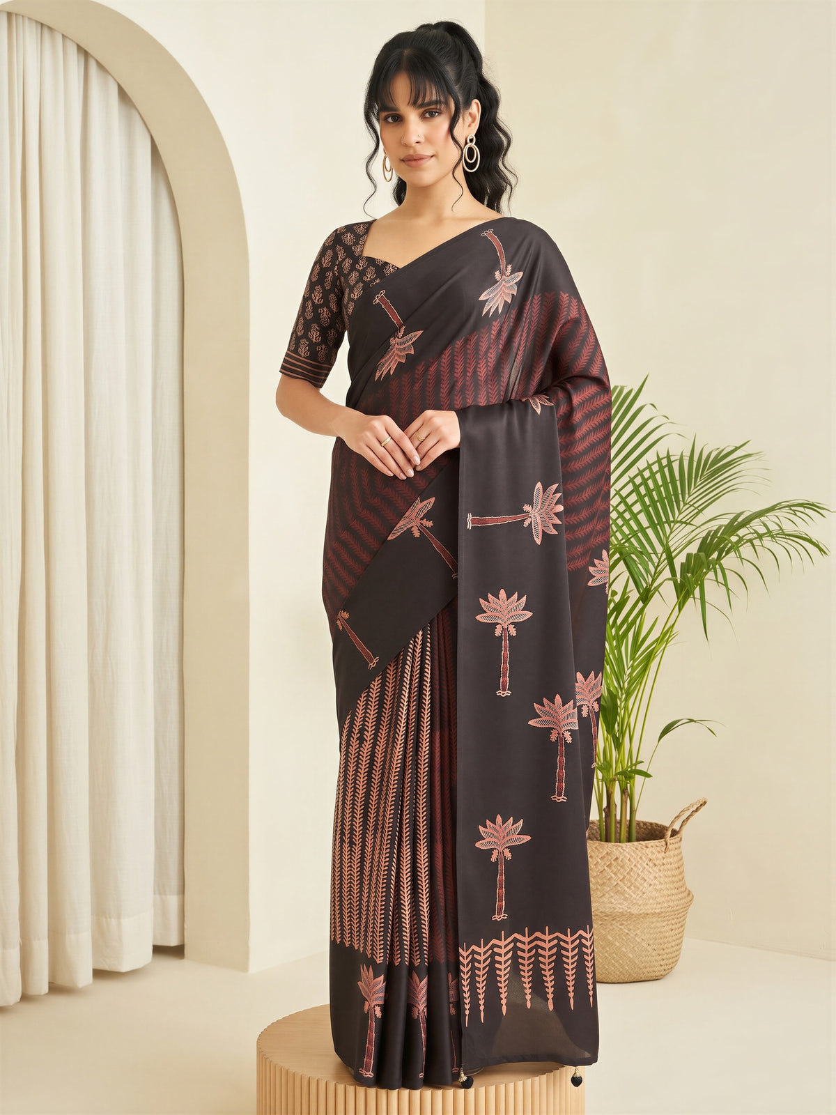 Woman wearing black silk blend saree with traditional indian motif work and black blouse