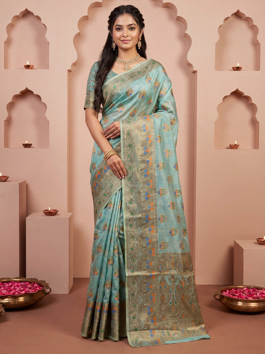 Woman wearing light blue silk blend saree with zari butta (metallic motif) work and light blue blouse