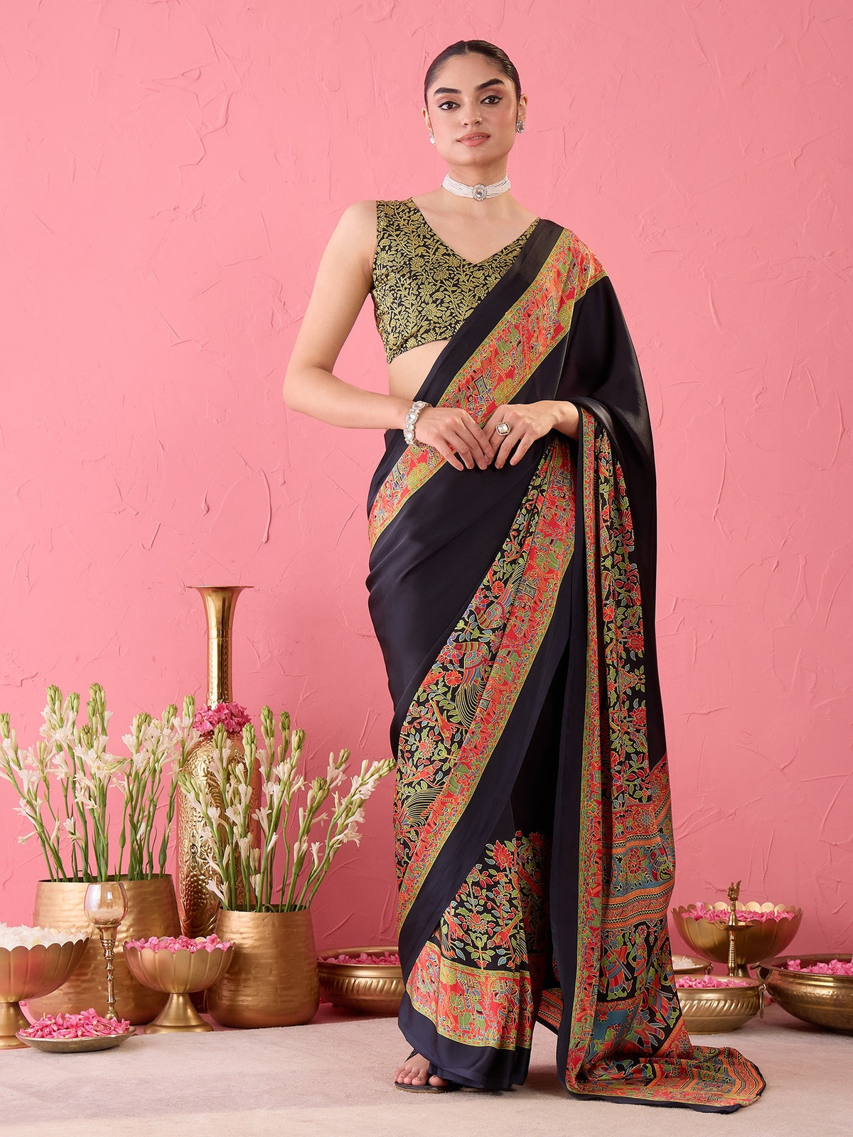 Woman wearing black satin ready to wear saree with madhubani folk-art motifs and black blouse