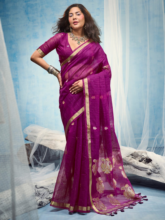 Woman wearing magenta muga silk saree with zari butta (metallic motif) work and magenta blouse