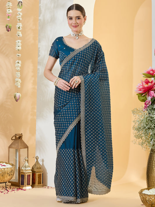 Woman wearing teal blue satin saree with embroidered motif work and teal blue blouse