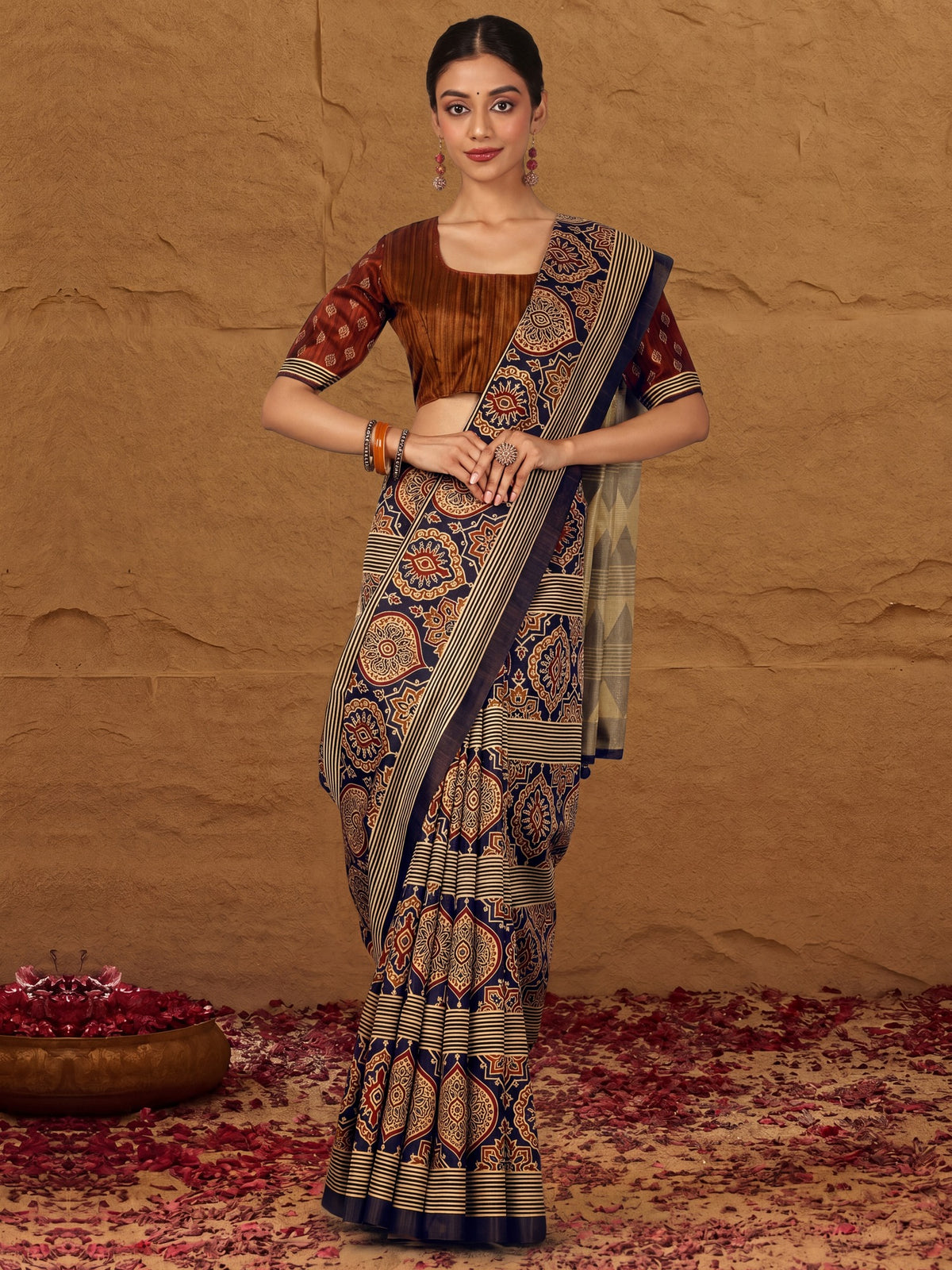 Woman wearing navy blue silk blend saree with traditional indian motif work and camel brown blouse