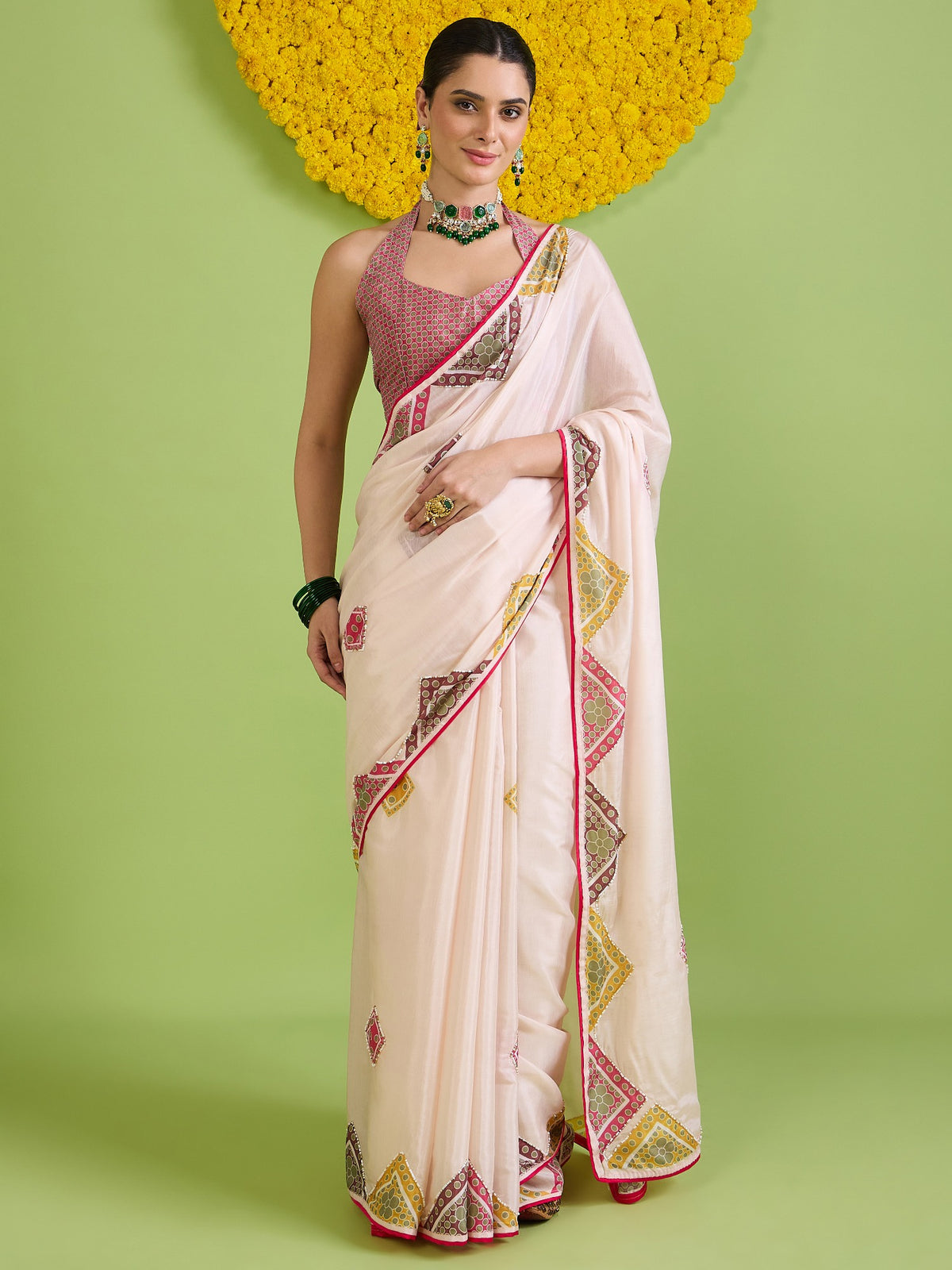 Woman wearing off white cotton silk saree with traditional indian motif work and pink blouse
