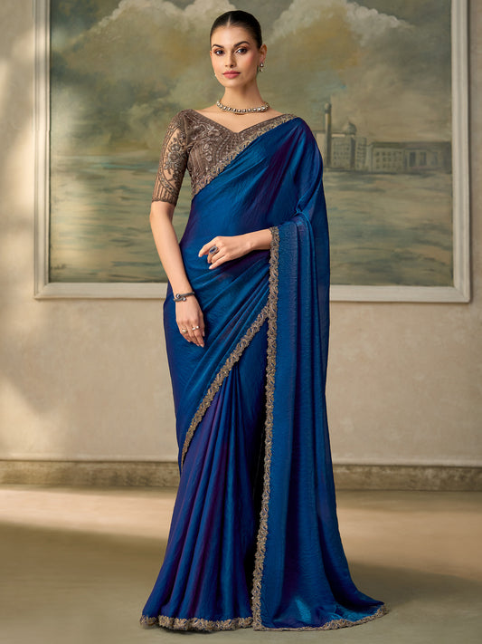 Woman wearing blue satin silk saree with embroidered motif work and grey melange blouse