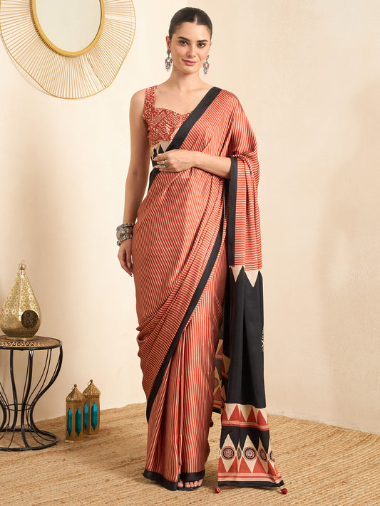 Woman wearing maroon pure crepe saree with striped pattern design and maroon blouse
