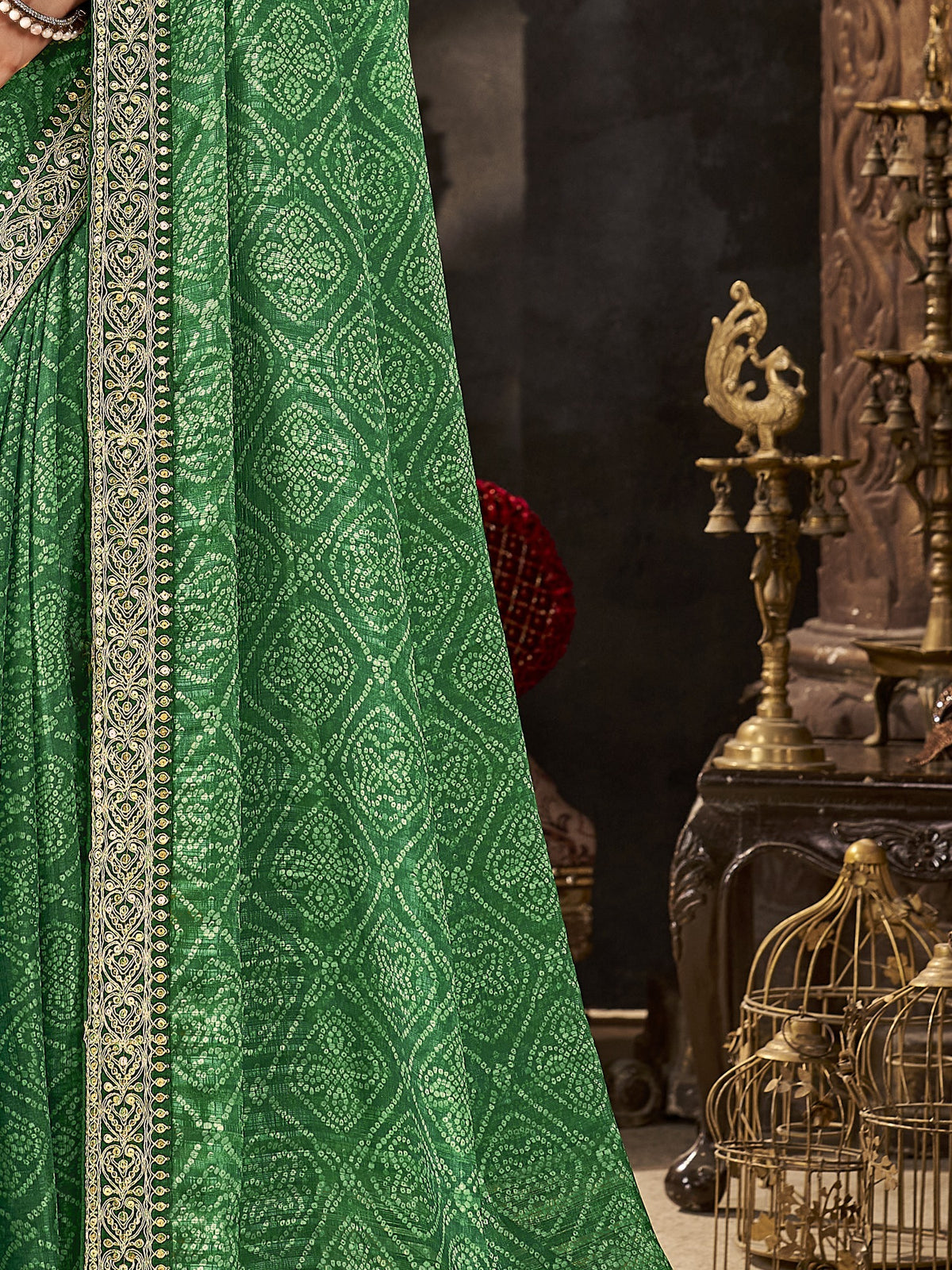 Pallu detail of green chiffon saree showing bandhani tie-dye dot work and embellished border