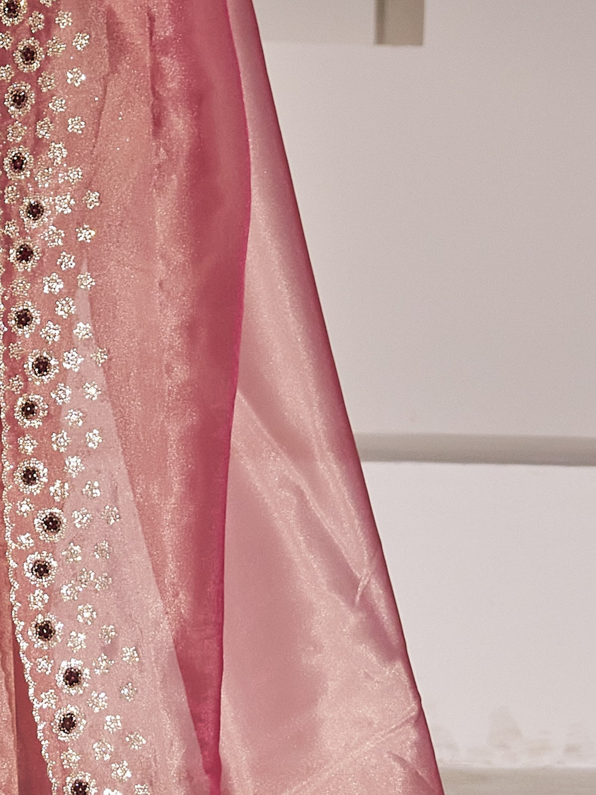 Pallu detail of pink organza saree showing applique design and scallop border