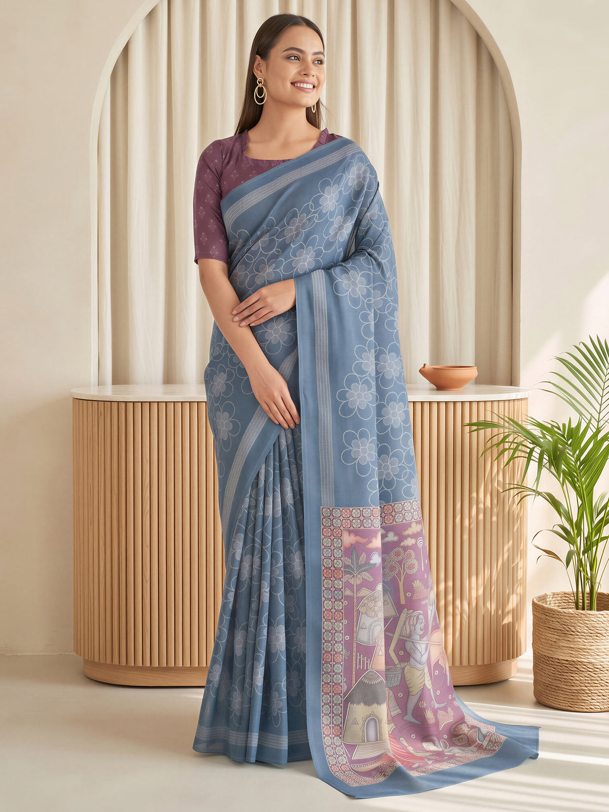 Woman wearing teal blue linen blend saree with traditional indian motif work and purple blouse
