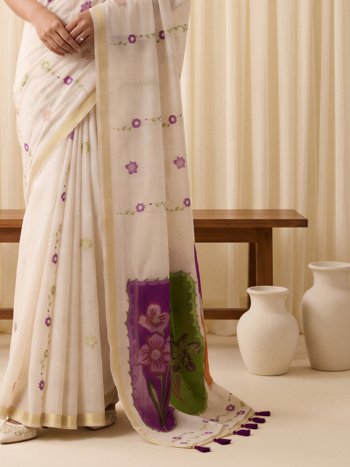 Pallu detail of off white cotton blend saree showing traditional indian motif work and zari border