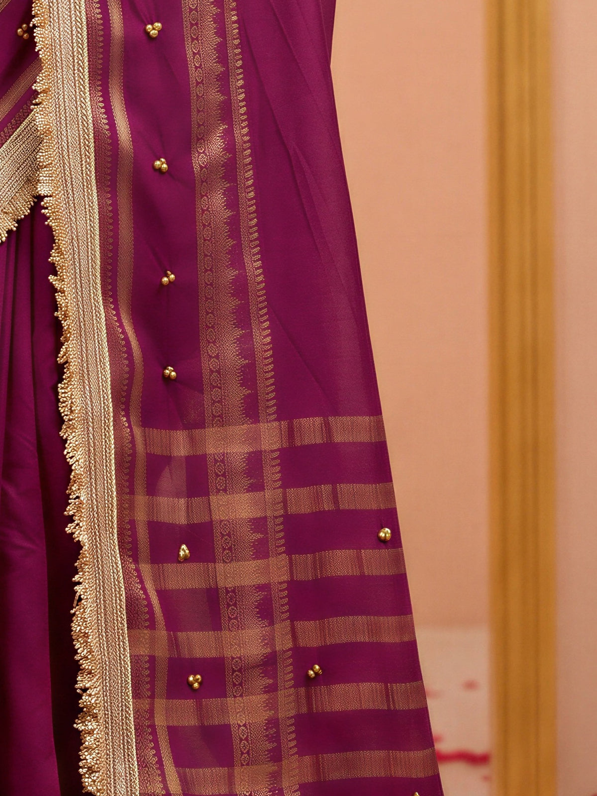 Pallu detail of purple soft silk saree showing woven motif design and zari border
