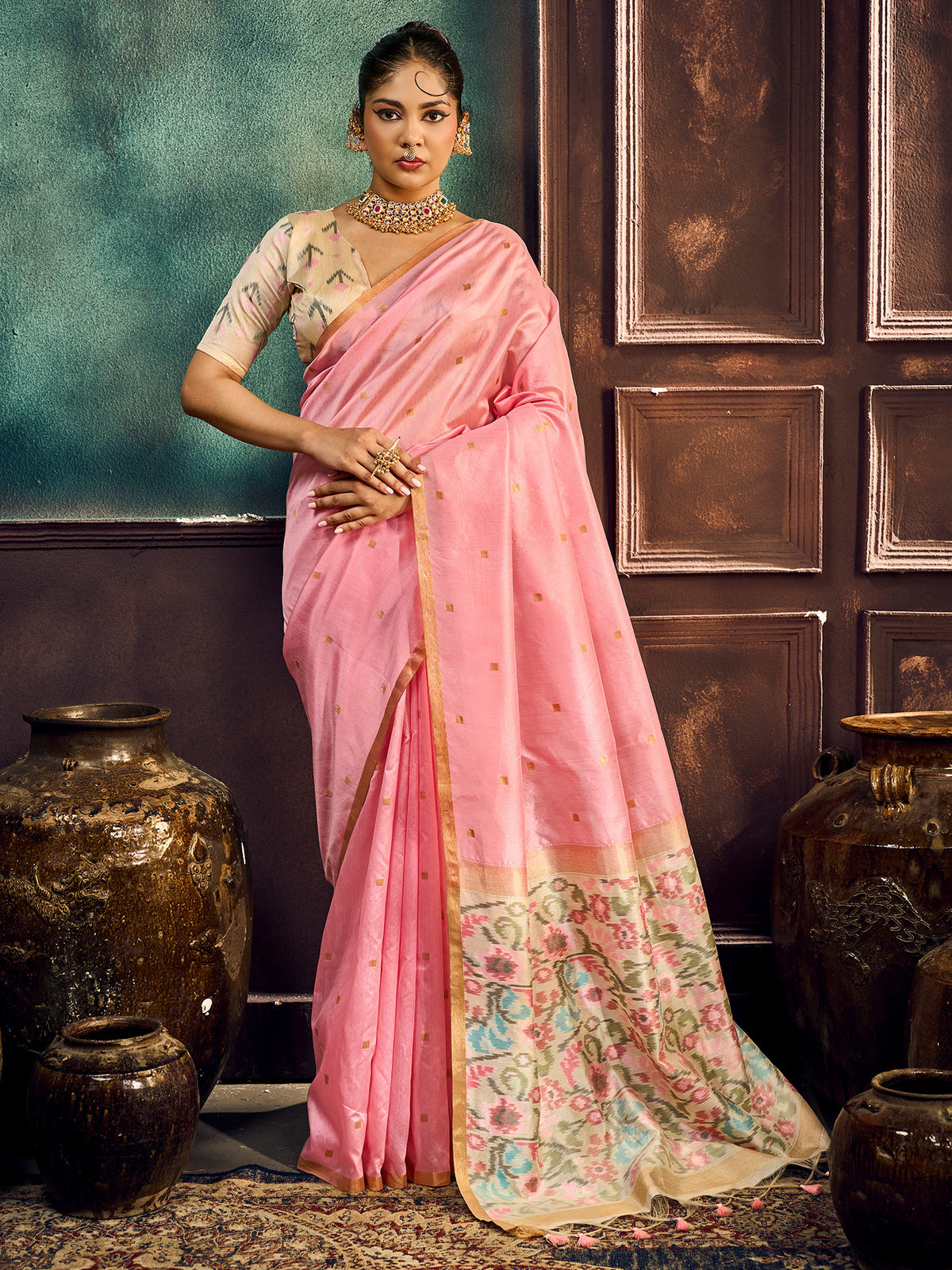 Woman wearing pink cotton silk saree with zari butta (metallic motif) work and pink blouse