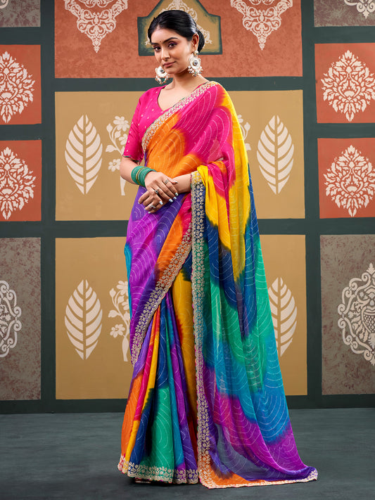Woman wearing multicolored chiffon saree with bandhani tie-dye dot work and pink blouse