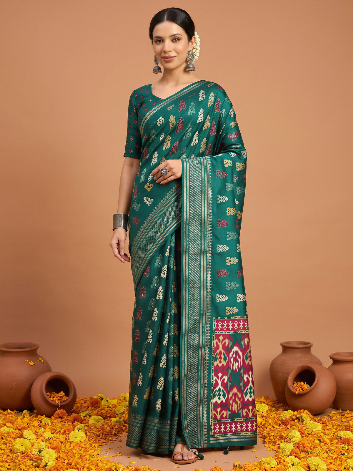 Woman wearing teal green silk blend saree with metallic foil print work and teal green blouse