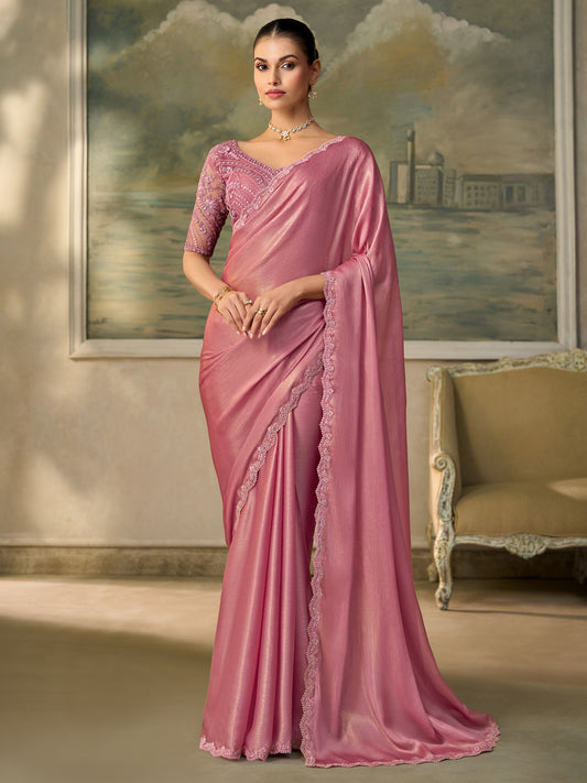 Woman wearing pink chiffon saree with embroidered motif work and pink blouse