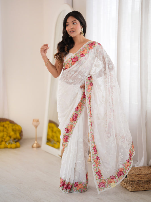 Woman wearing white georgette saree with all-over floral design and white blouse