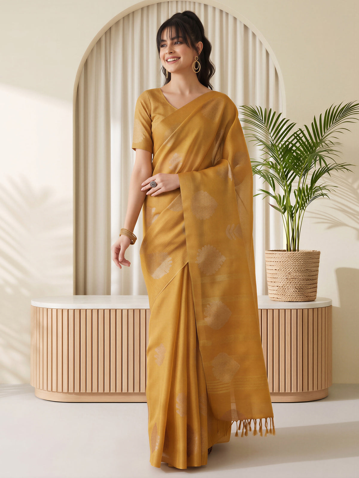 Woman wearing mustard linen saree with traditional indian motif work and mustard blouse