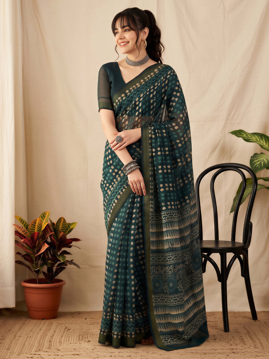 Woman wearing teal blue cotton linen saree with batik wax-resist design and teal blue blouse