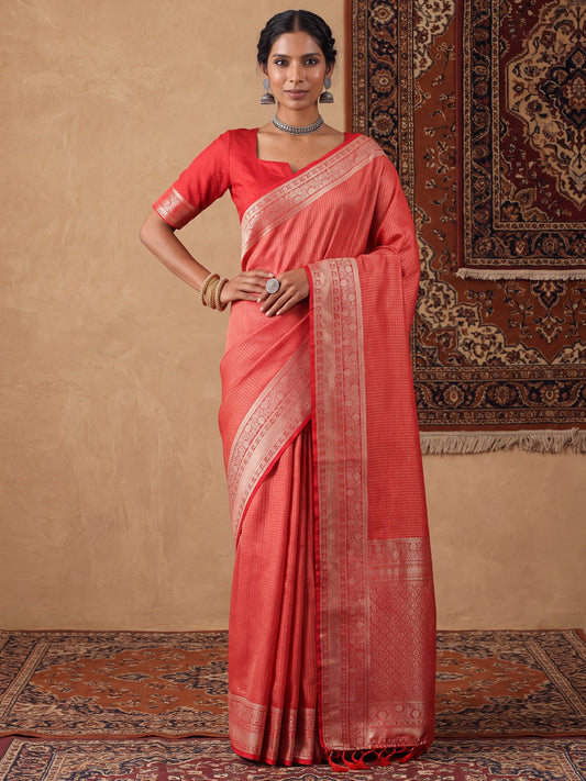 Woman wearing red satin silk saree with checkered design and red blouse