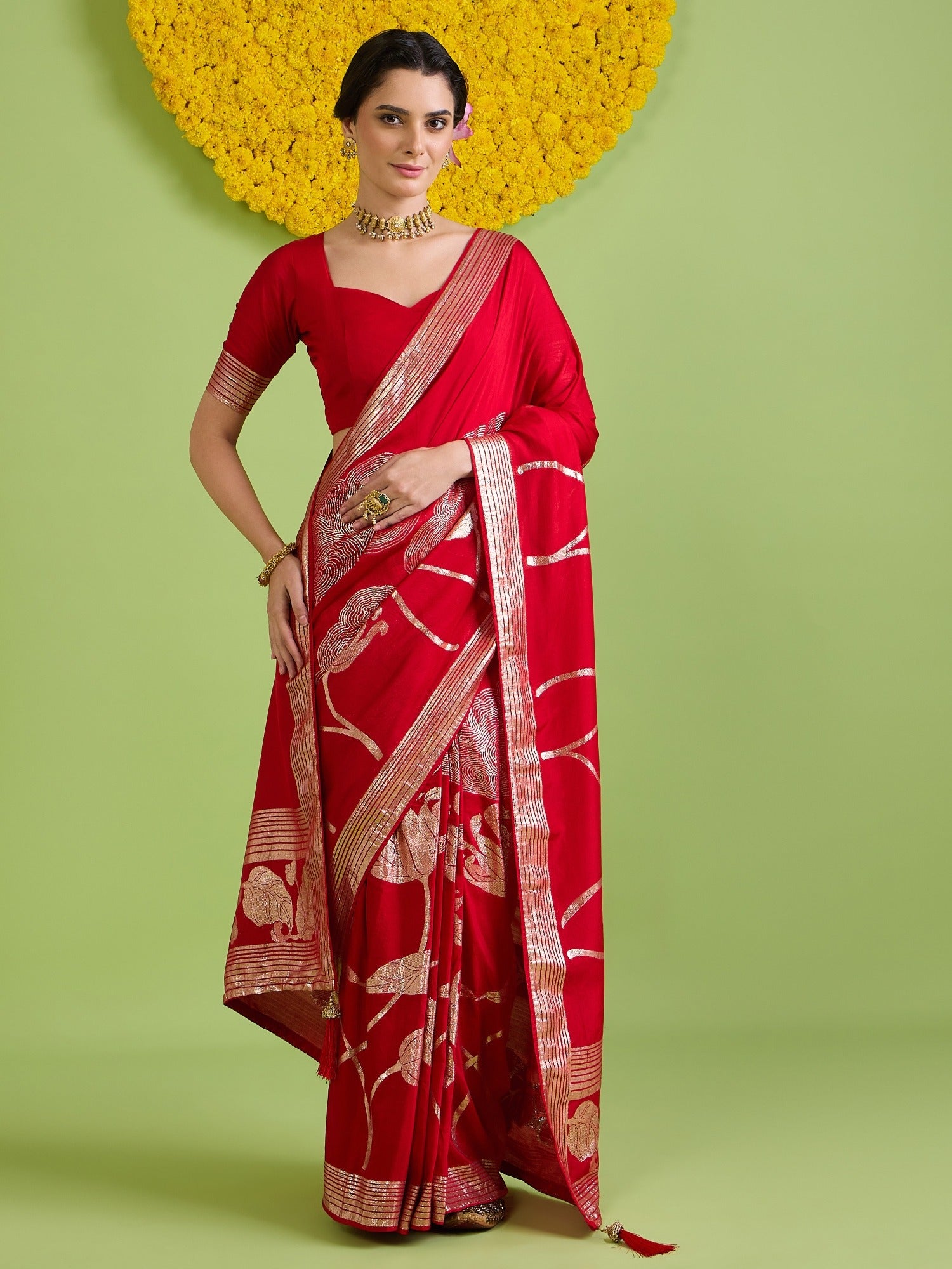 Woman wearing red silk blend saree with all-over floral design and red blouse