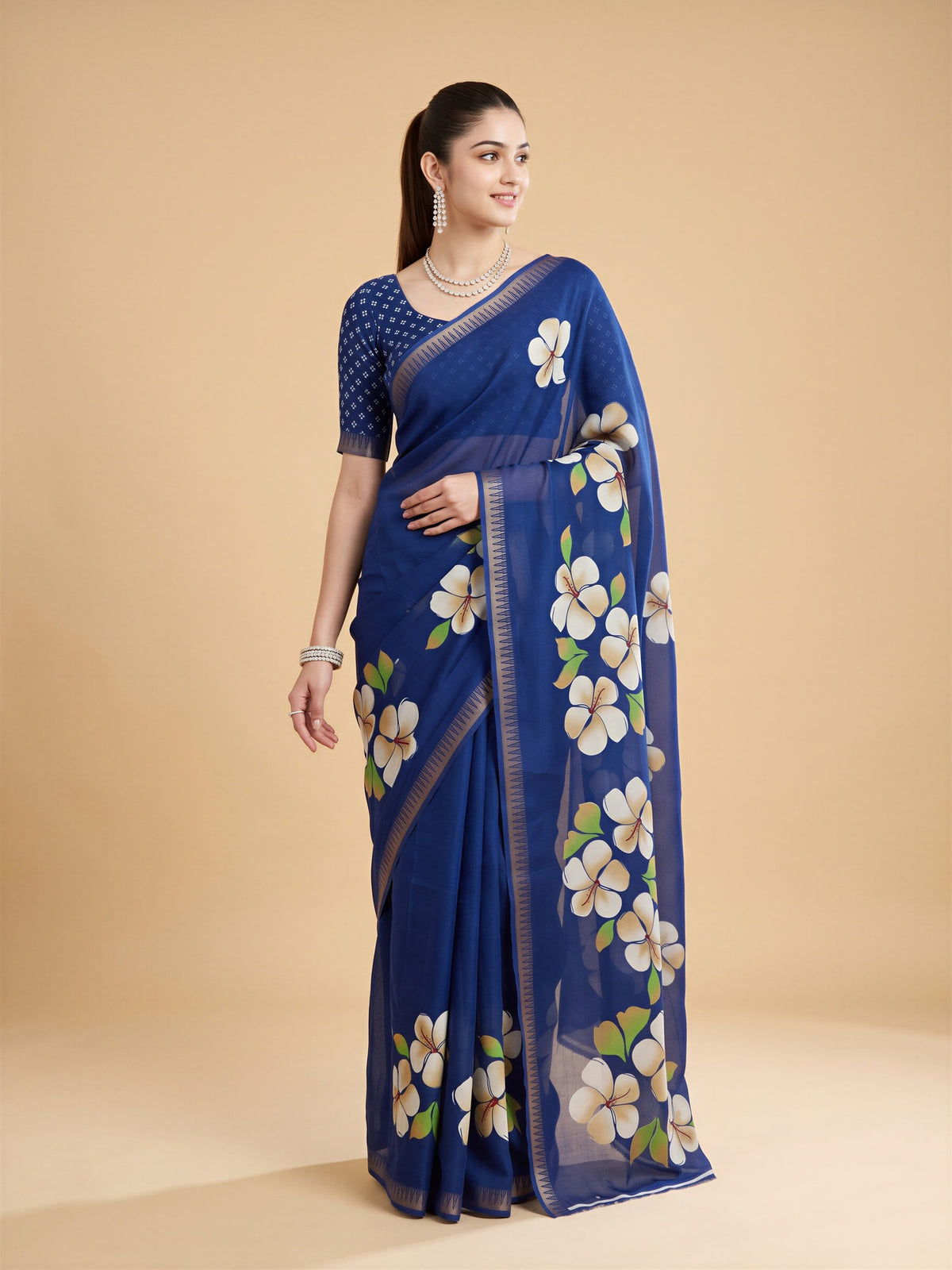 Woman wearing blue georgette saree with all-over floral design and blue blouse