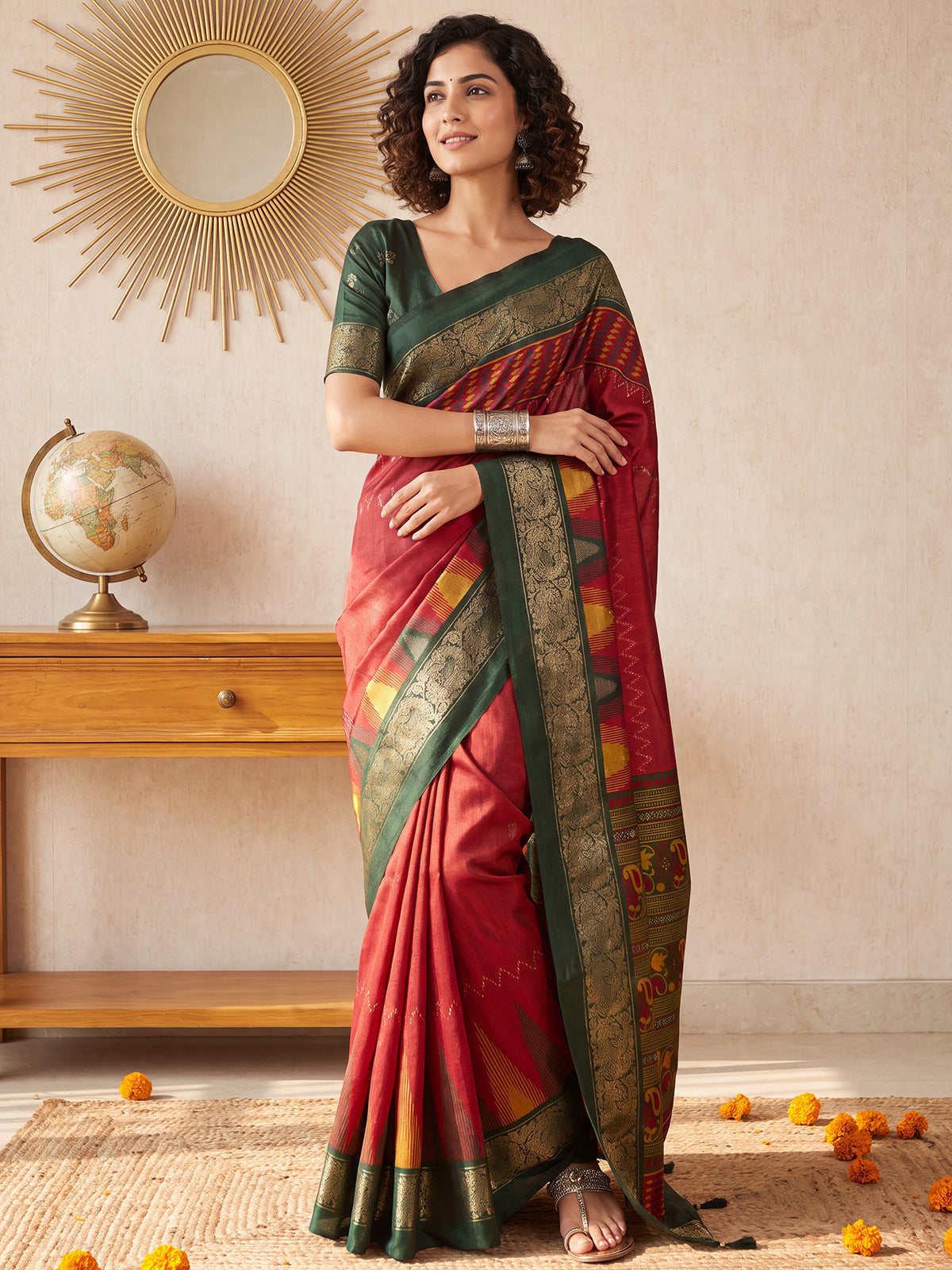 Woman wearing red tussar silk saree with traditional indian print motifs and dark green blouse