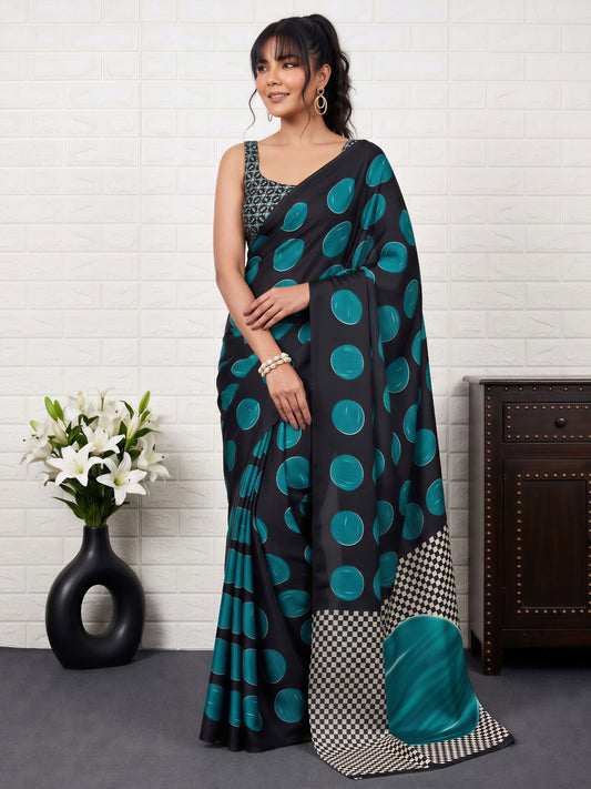 Woman wearing teal blue satin saree with traditional indian motif work and black blouse
